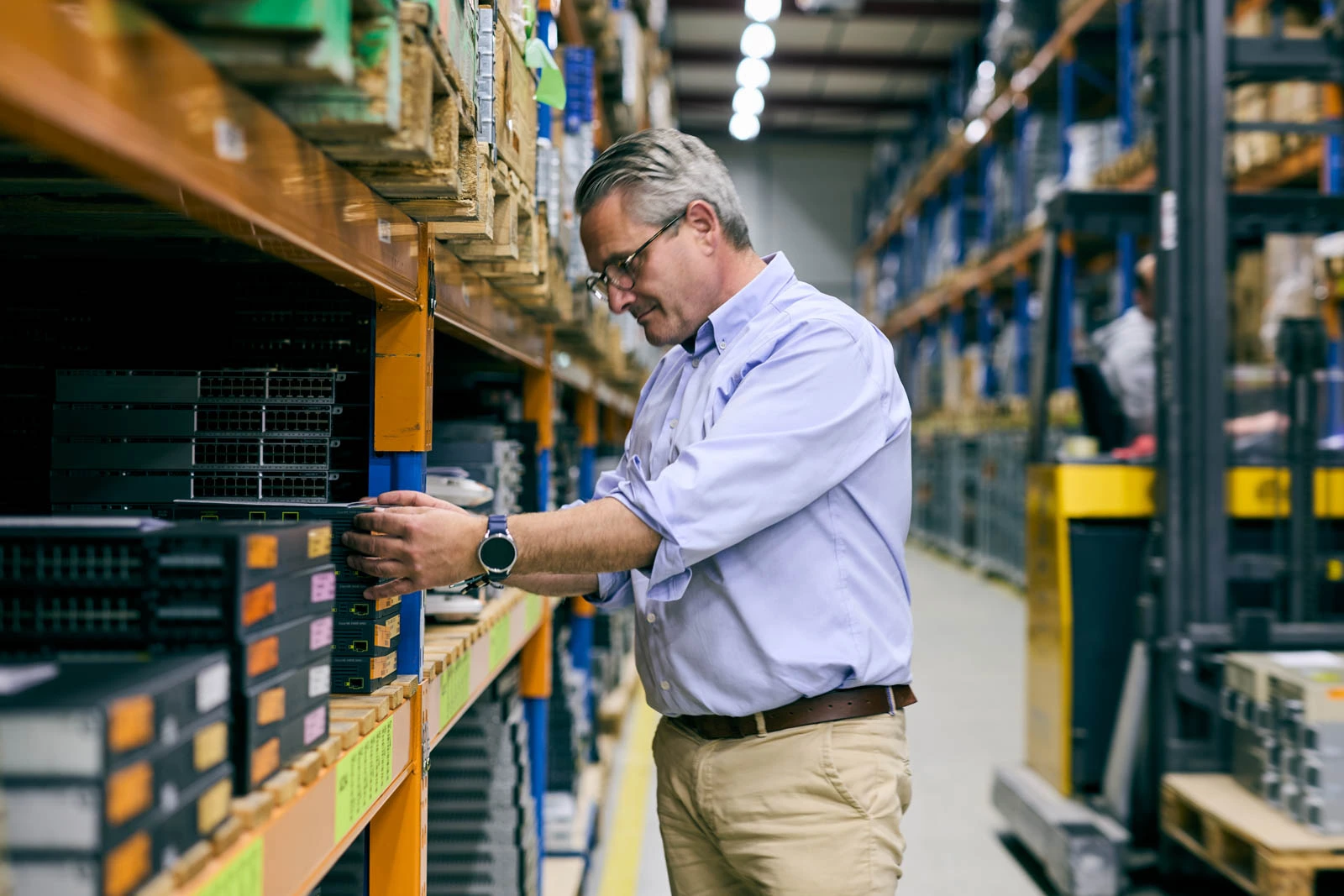Technician organising enterprise networking hardware during RAM shortage supply pressure
